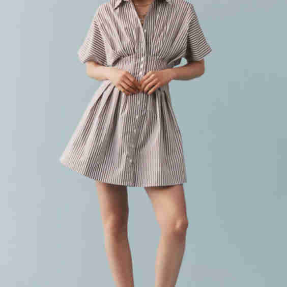 The @heynasreen Tobie Button-Front Pleated Mini Shirt Dress by Exquise